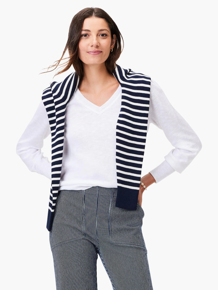 Here's alt text for the image, suitable for visually impaired users:

"White slub V-neck sweater. Model also wears a navy...