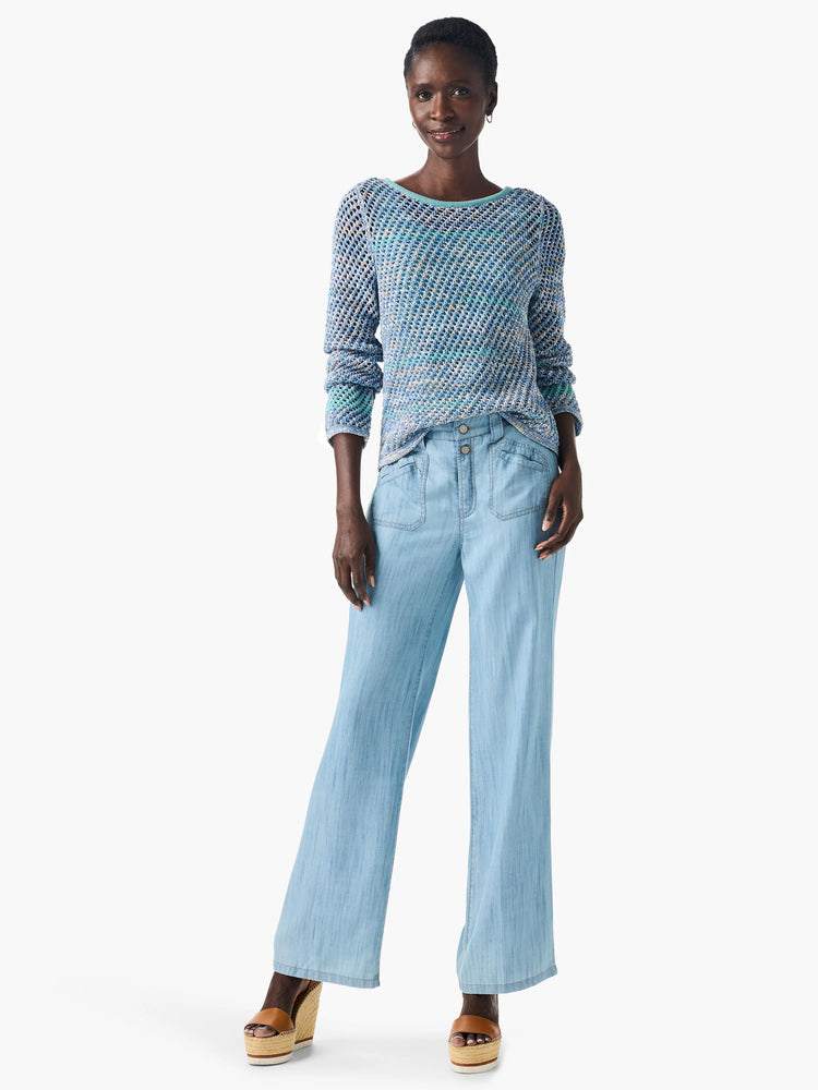 Crochet sweater in blue, teal, and cream;  open-weave pattern.