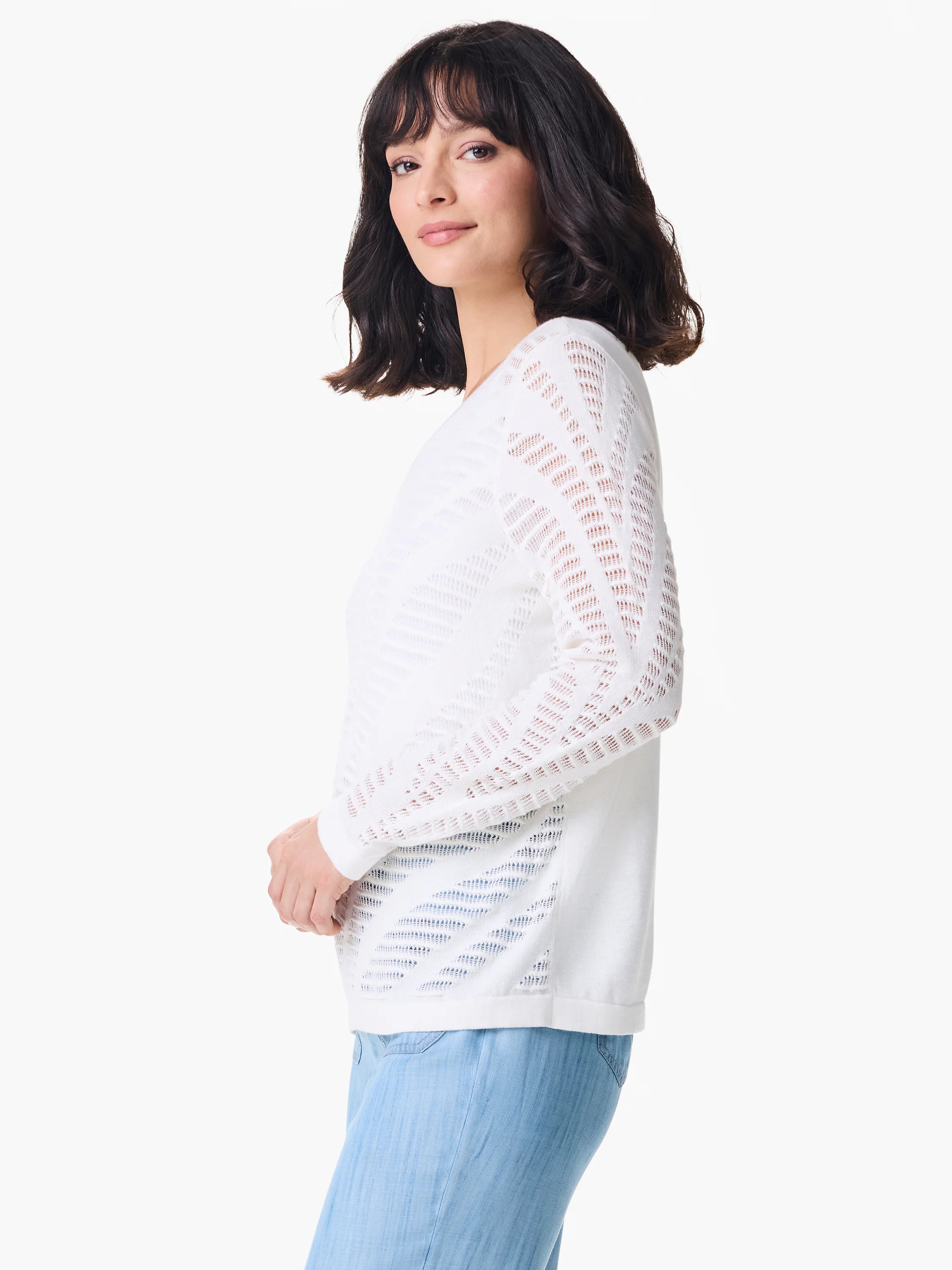 White pointelle long-sleeve sweater.  Patterned with repeating cut-outs.