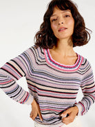 Striped crocheted sweater in muted pinks, purples, grays, and black.  Crew neck, long sleeves.