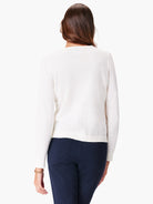 Off-white long-sleeve sweater, shown from the back.  The sweater has a ribbed hem.