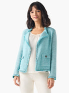 Turquoise tweed jacket with fringe trim on edges and two front flap pockets.