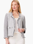 Off-white jacket with black grid pattern & frayed edges.  Three-quarter sleeves, pockets, and double-breasted closure.