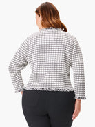 Off-white jacket with a black grid pattern and frayed edges. Long sleeves.