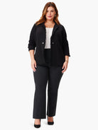 Black knit jacket with long fringe detailing.  Features two buttons.