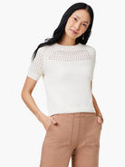 Off-white crochet-detail sweater tee with short sleeves.  The yoke and sleeves feature open-weave detailing.