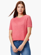 Pink crocheted sweater tee with short sleeves and a round neck.  The neckline and shoulders feature an open-weave pattern.