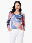 4-way cardigan in blue, pink, red, & black abstract print.  Long sleeves, wrap style.