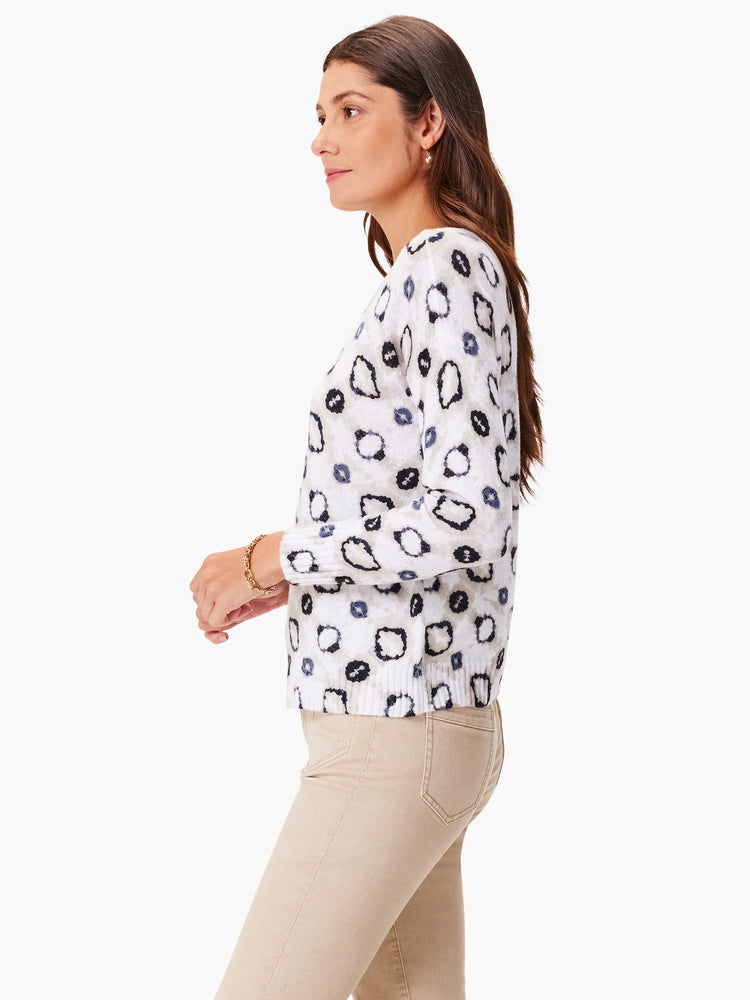Off-white sweater with dark gray and black abstract spots.  Three-quarter sleeves.