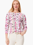 Geo Mosaic Sweater:  Pink, beige, and gray geometric pattern on a white background. Long sleeves, crew neck.