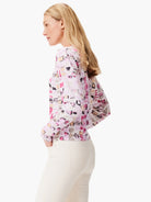 Long-sleeve sweater; pink, beige, and black geometric mosaic pattern on white background.
