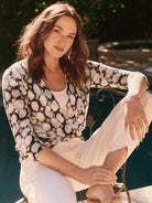 Beige, brown, and teal patterned 4-way cardigan.  Three-quarter sleeves, open front.