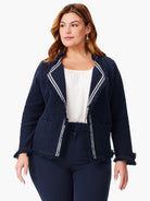 Navy blue knit jacket with white trim and fringe detailing.  Open front.