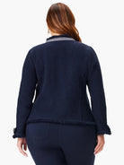 Dark navy blue knit jacket with white trim, fringe along hem and sleeves.  Zipper detail at neckline.