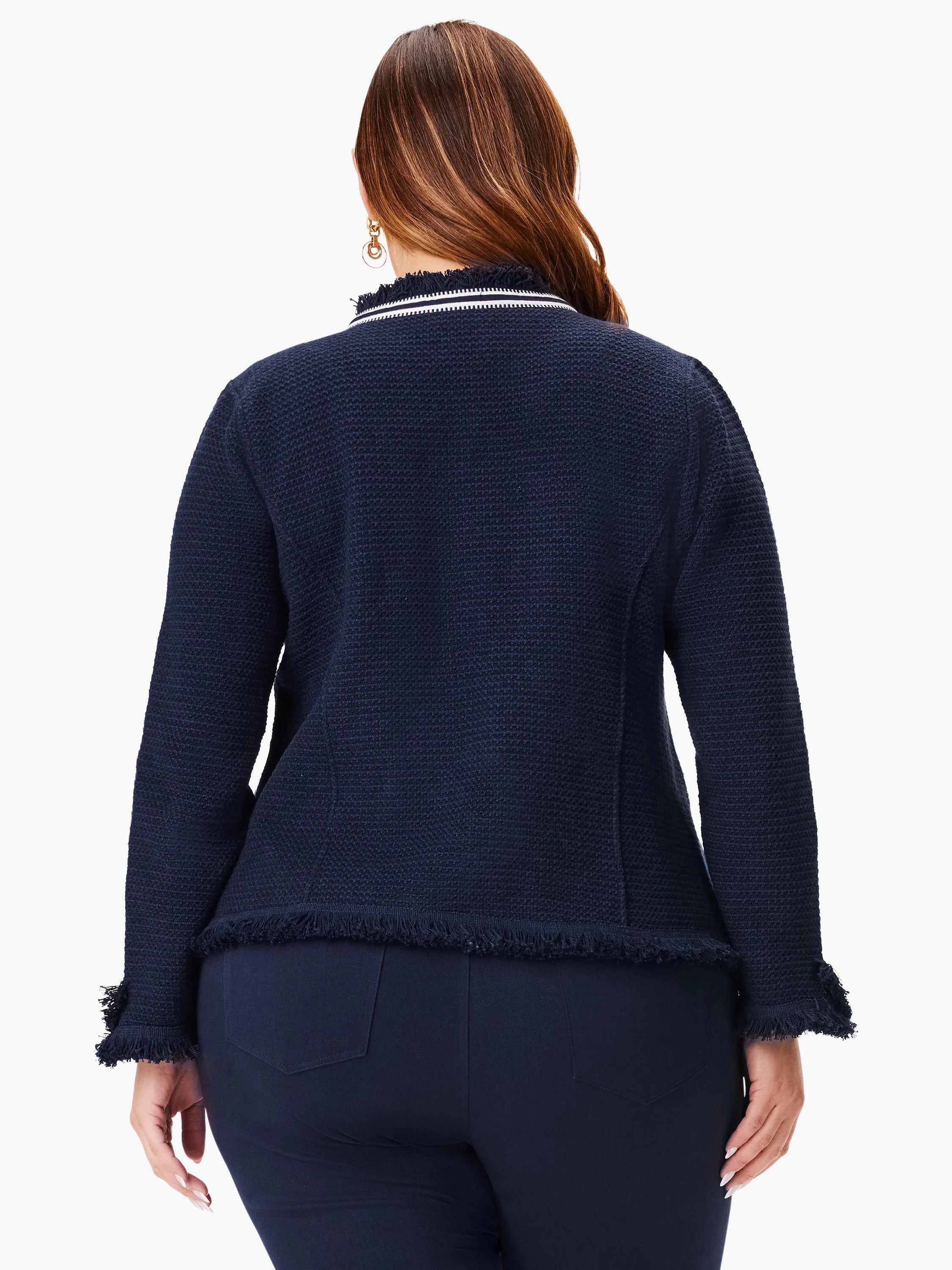 Dark navy blue knit jacket with white trim, fringe along hem and sleeves.  Zipper detail at neckline.
