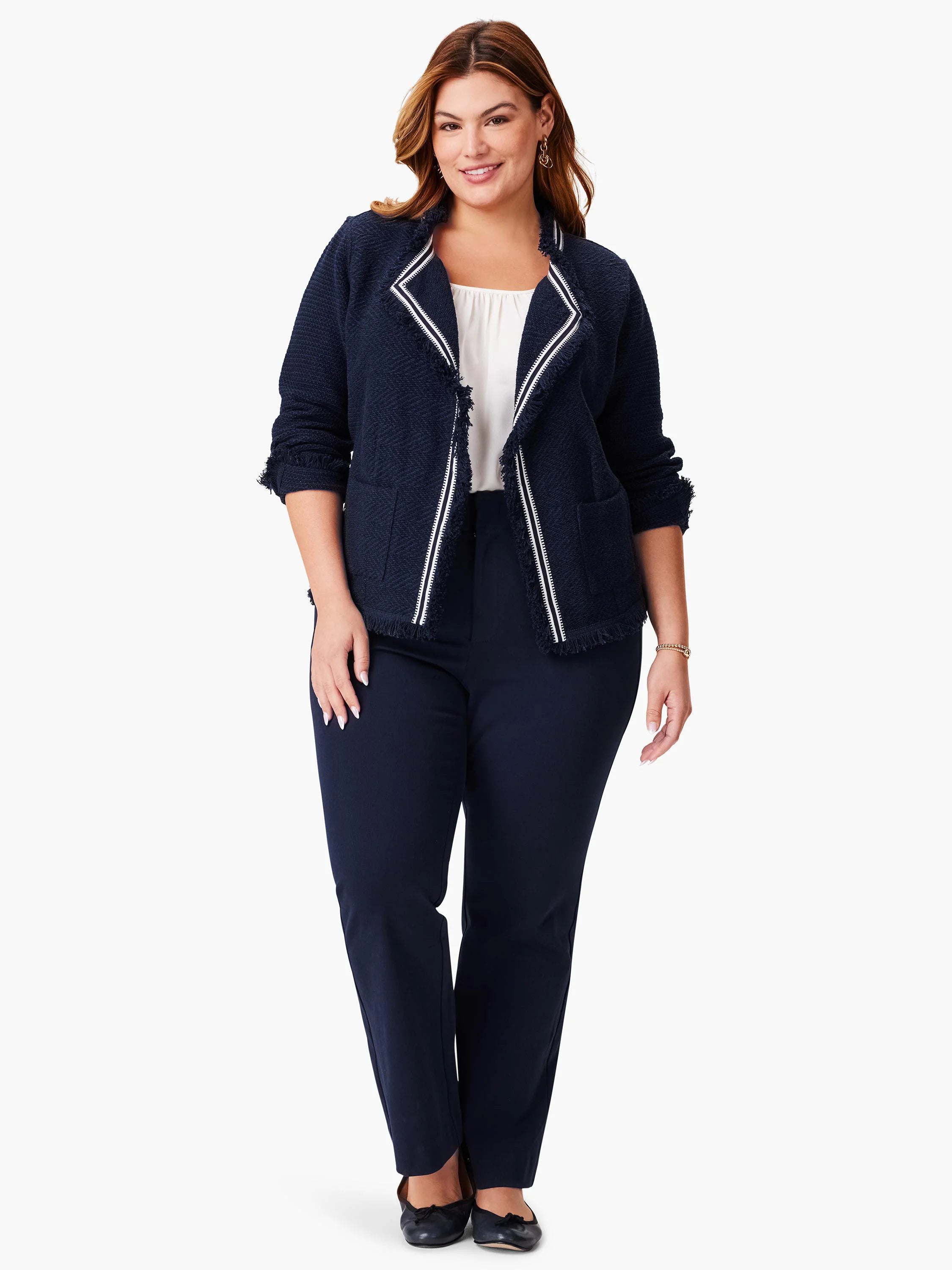 Navy blue knit jacket with white trim and fringe detailing.  Open front.