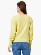Light yellow sweater with puff sleeves and ribbed trim.