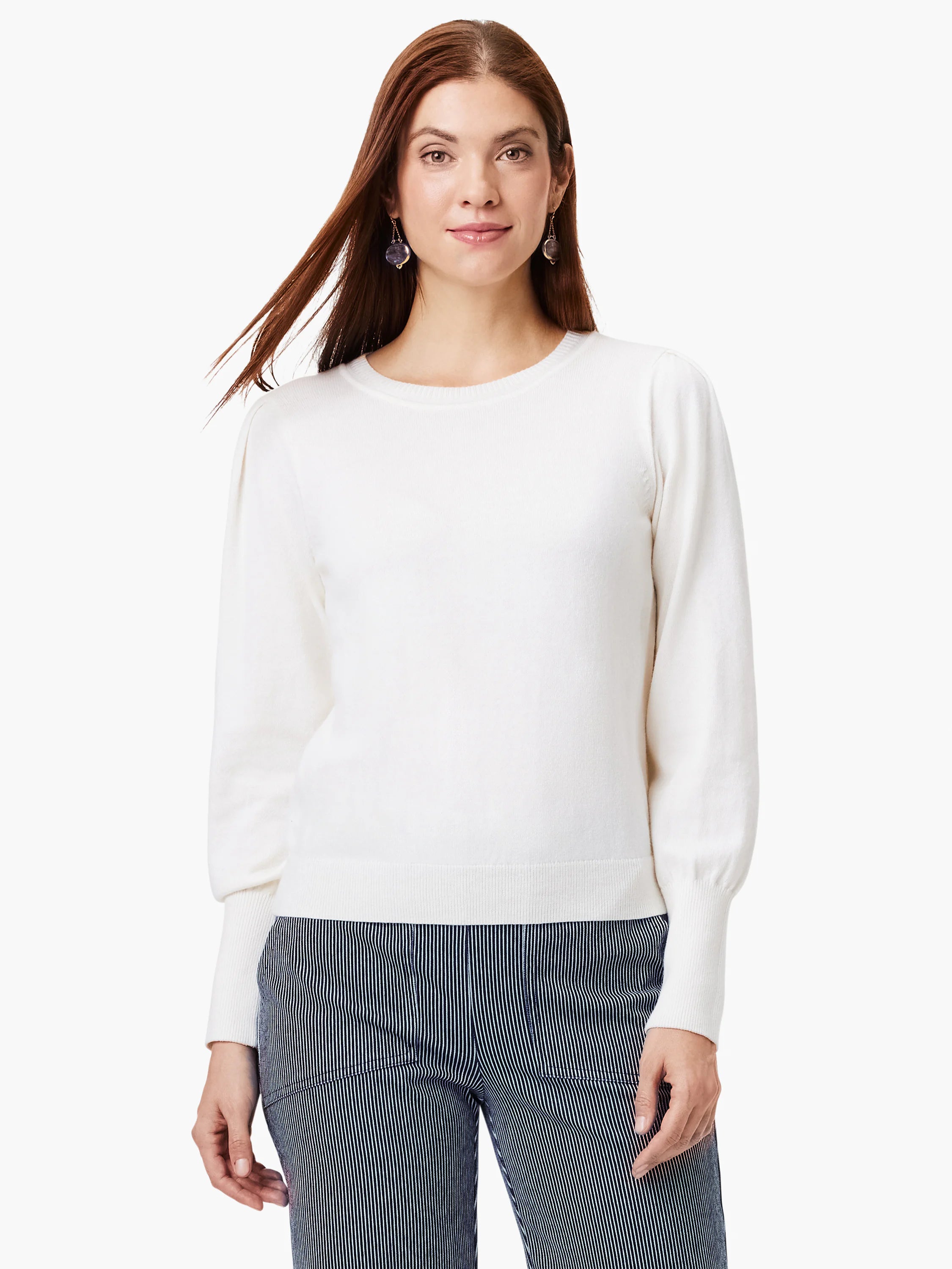 Cream crewneck sweater with subtly puffed sleeves, long ribbed cuffs, and ribbed hem.
