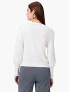 Off-white sweater, back view. Features include a round neck, puff sleeves with ribbed cuffs, and a ribbed hem.