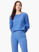 Blue knit sweater with crew neck and gathered puff sleeves.