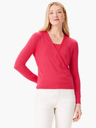 Bright red wrap cardigan with V-neck, long sleeves, and ribbed cuffs & hem, worn over a matching top.