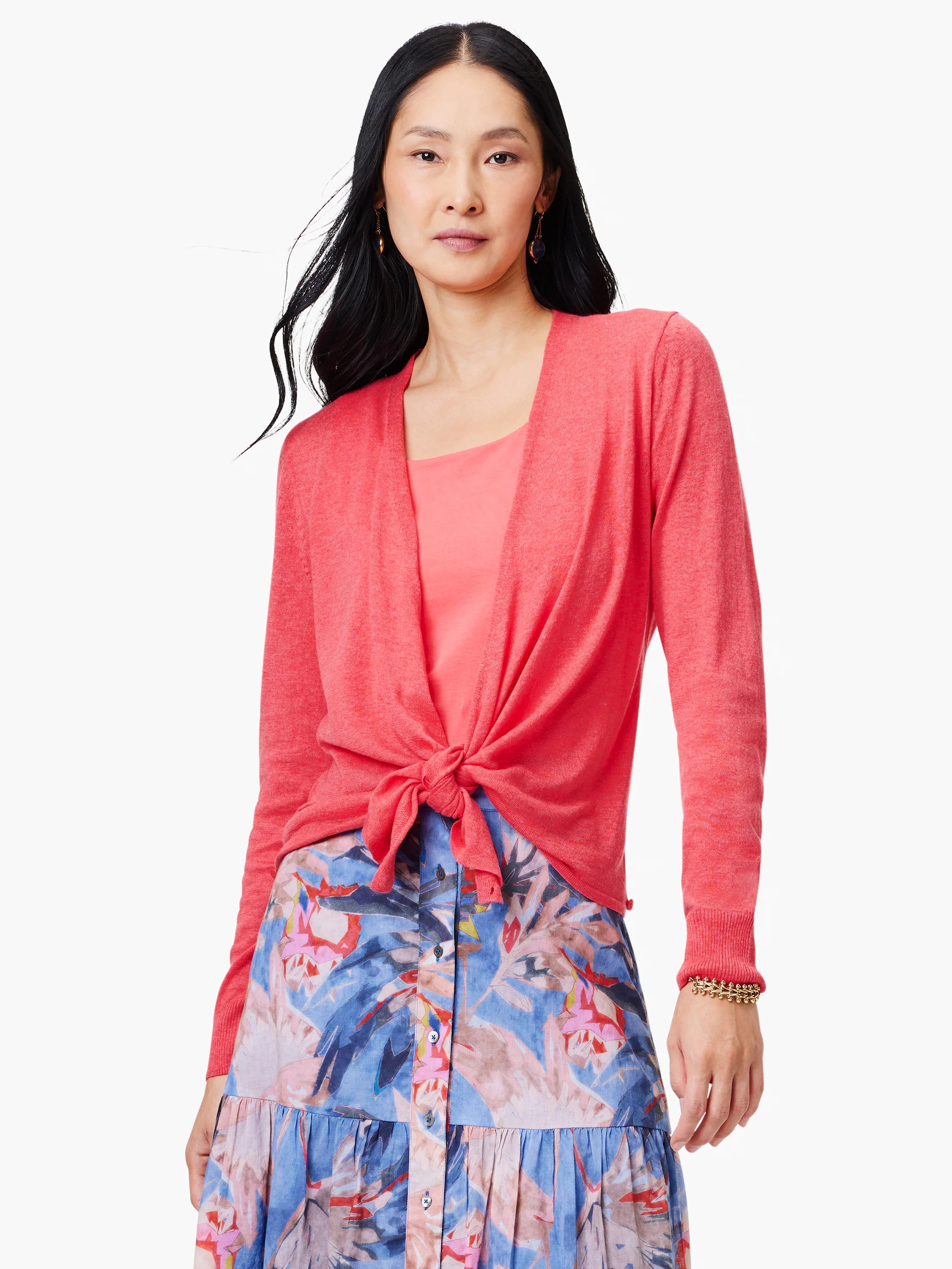 Long-sleeved coral pink knit cardigan, shown tied at the waist over a lighter pink top.