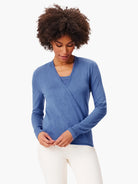 Blue fine knit wrap cardigan with long sleeves, worn over a matching blue camisole.