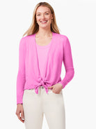 Bright pink open cardigan, long sleeves, tied at waist, worn over a lighter pink tank top.