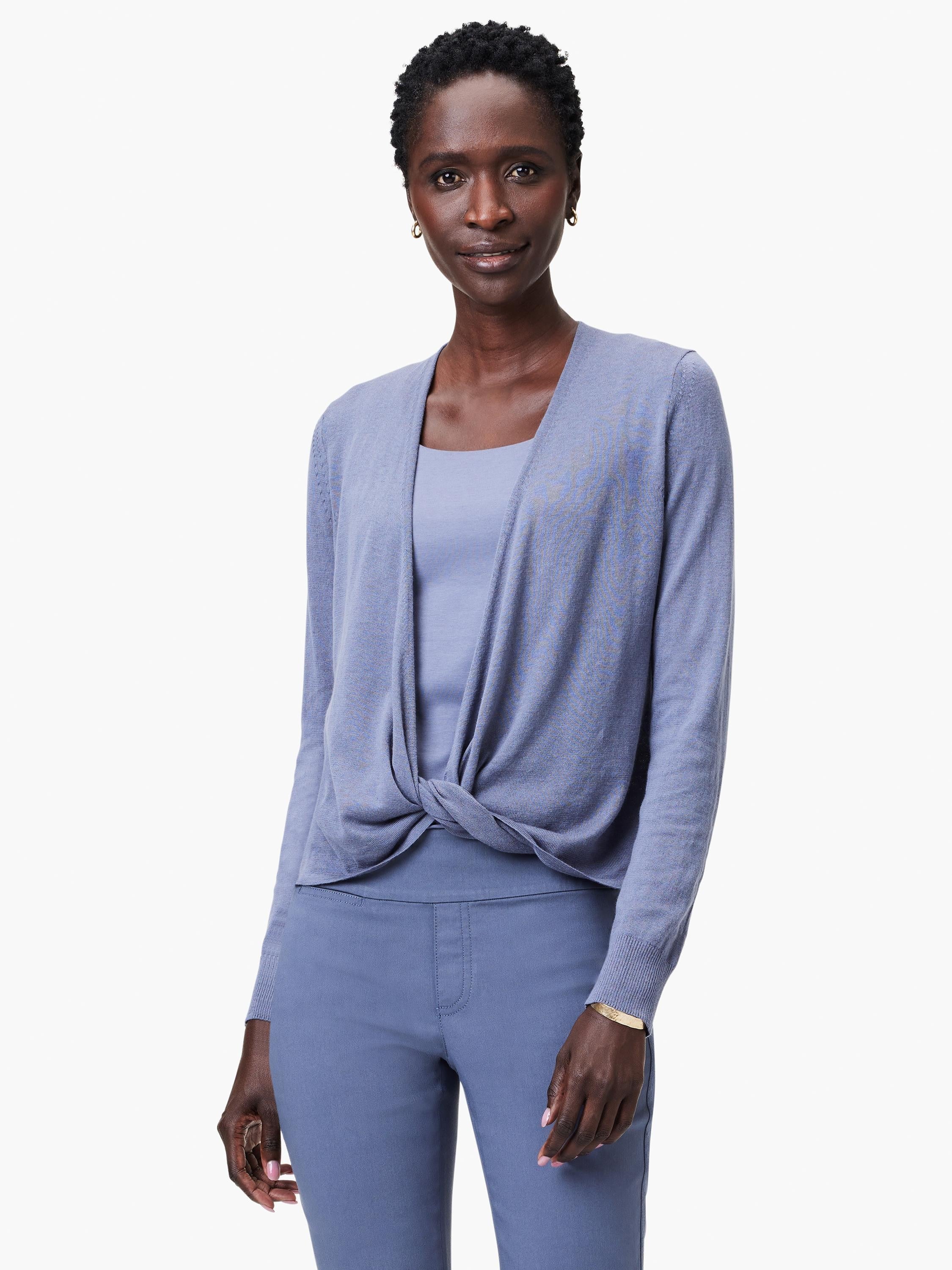Periwinkle blue cardigan, tied in a front knot over a matching top. Features long sleeves and an open front.