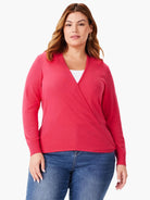 Coral pink, fine-knit wrap cardigan featuring a V-neck, long sleeves, and ribbed cuffs.