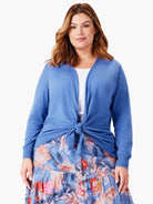 Cornflower blue long sleeve cardigan, styled open and tied in a knot at the waist.