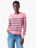 Pink cashmere sweater with dark blue horizontal stripes and shoulder buttons.