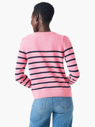 Pink cashmere sweater with dark-navy horizontal stripes, long sleeves, and slightly puffed shoulders.  Shown from the back.