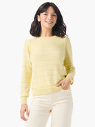 Pale yellow cashmere sweater with subtle horizontal stripes, round neck, and slightly puffed shoulders.