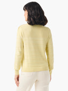 Pale yellow, ribbed cashmere sweater.  Button shoulders, long sleeves.  Back view.