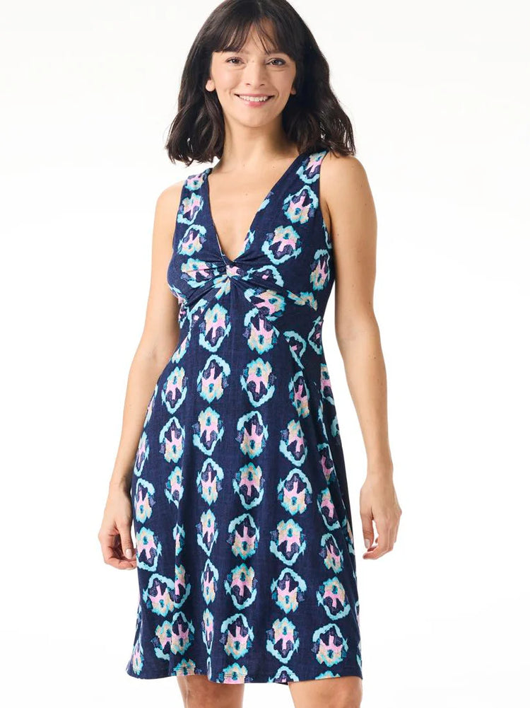 Navy sleeveless dress with a V-neck and knotted bodice. Features a teal, pink, and cream repeating geometric pattern.