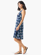Navy blue sleeveless dress with a V-neck and a repeating teal, pink, and beige ikat pattern.  A-line shape.
