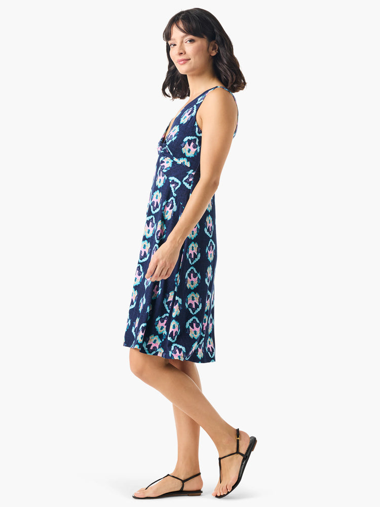Navy blue sleeveless dress with a V-neck and a repeating teal, pink, and beige ikat pattern.  A-line shape.