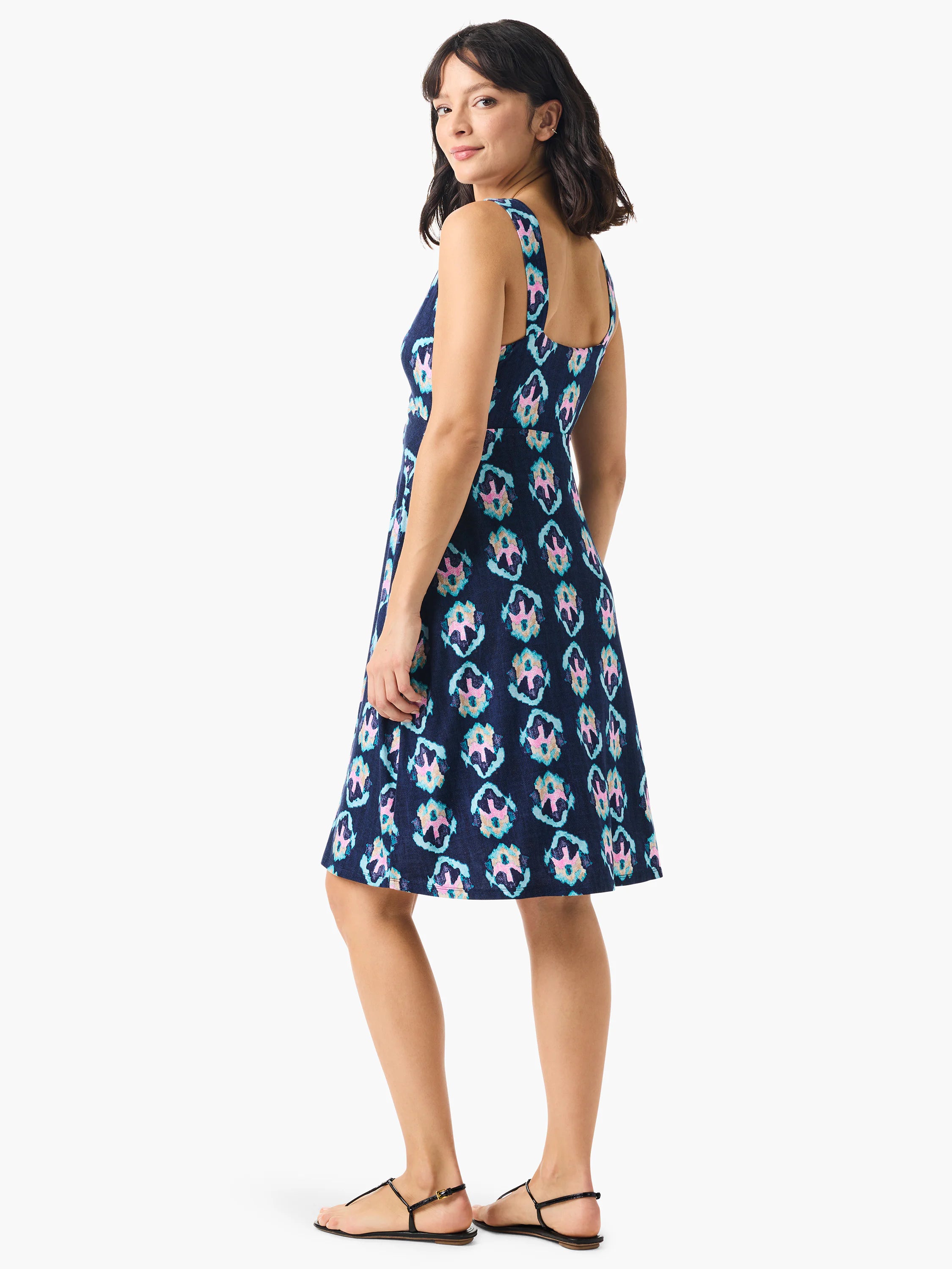 Navy blue sleeveless dress with a square neck, A-line shape, and pink, teal, and gold ikat pattern.
