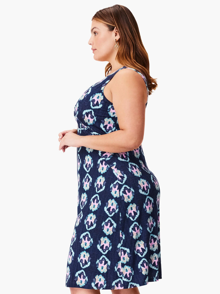 Navy sleeveless dress with a repeating pink, teal, and white floral pattern.  A-line silhouette.