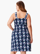 Dark navy sleeveless dress.  Ikat-style print in teal, pink, and beige. Square neckline. A-line shape.