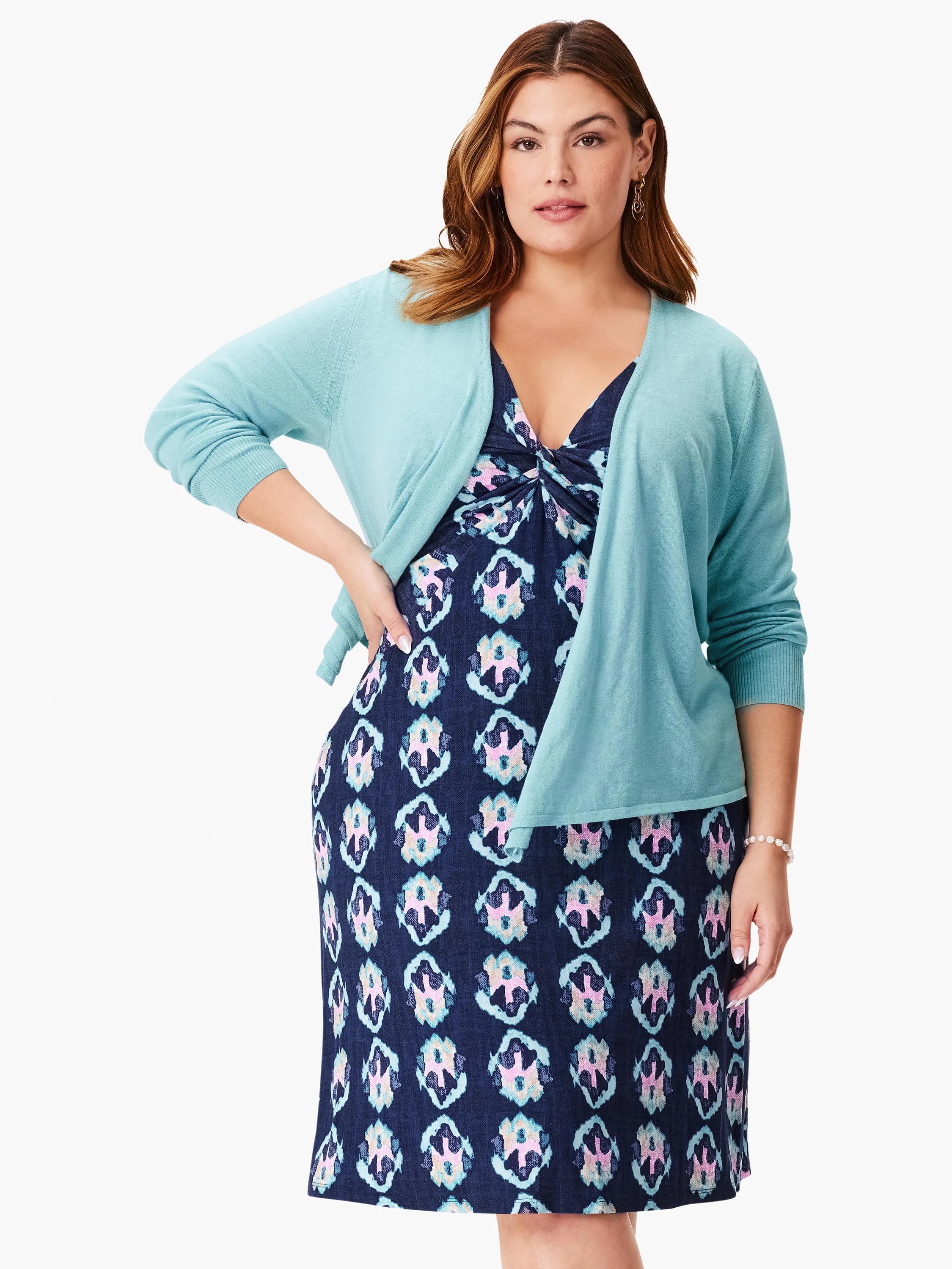 Navy blue dress with a teal blue open cardigan. Dress features a repeated pattern in teal, pink, and white.
