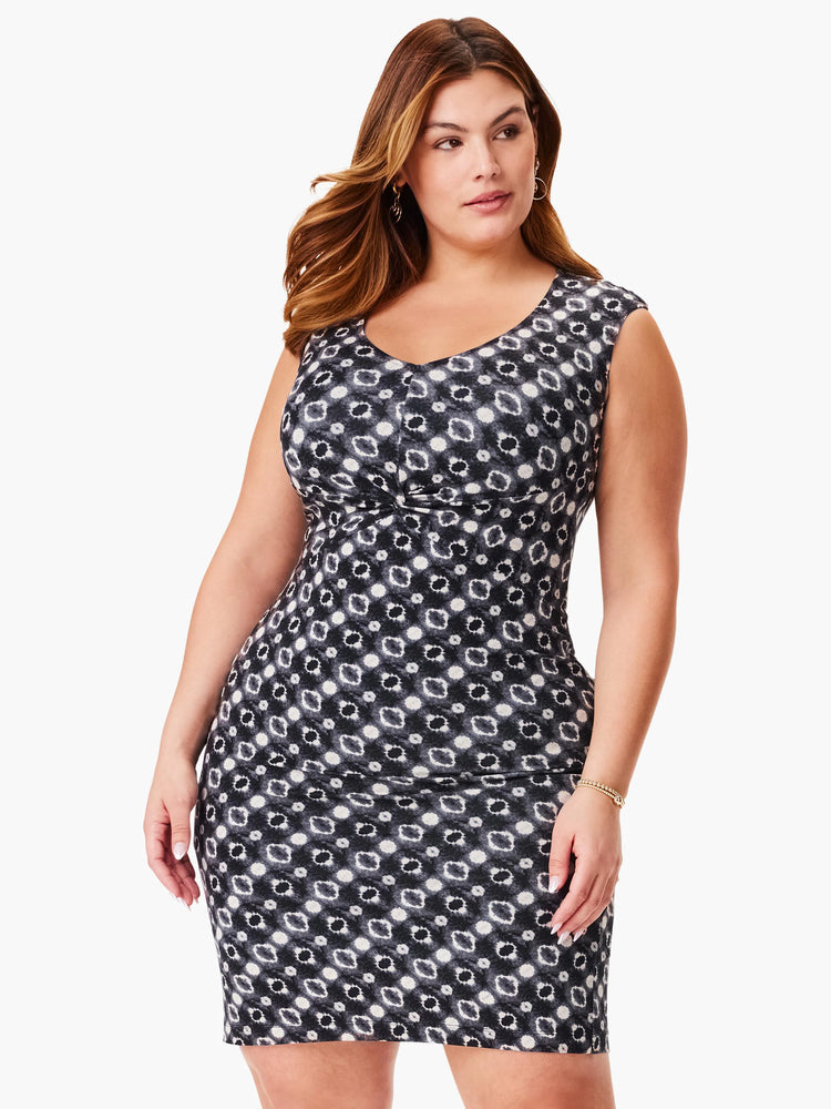 Black sleeveless dress with a V-neck and a repeating pattern of off-white and gray circles.  The dress is fitted.