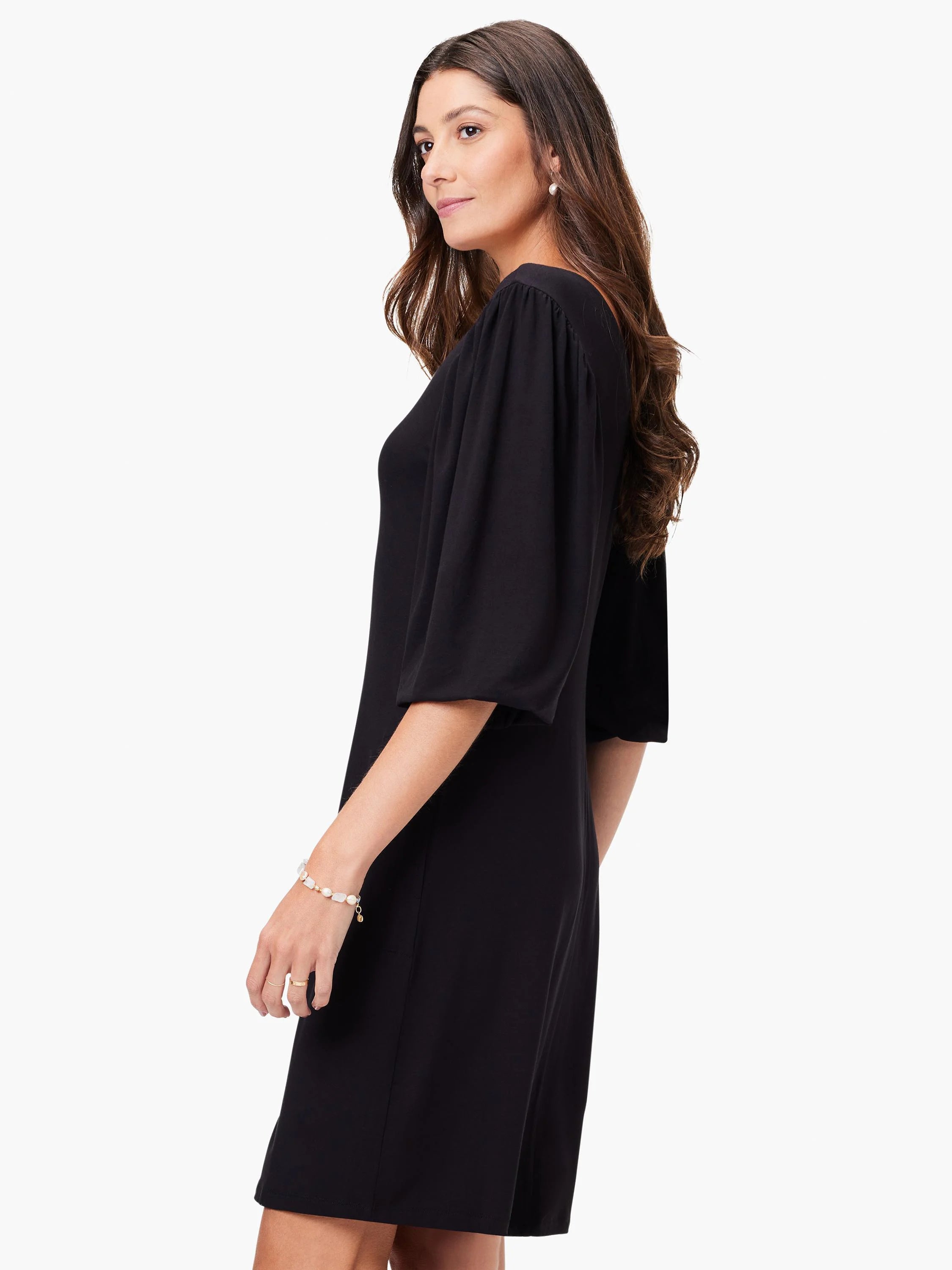 Black V-neck knit dress, short sleeves with slight puff, knee-length.