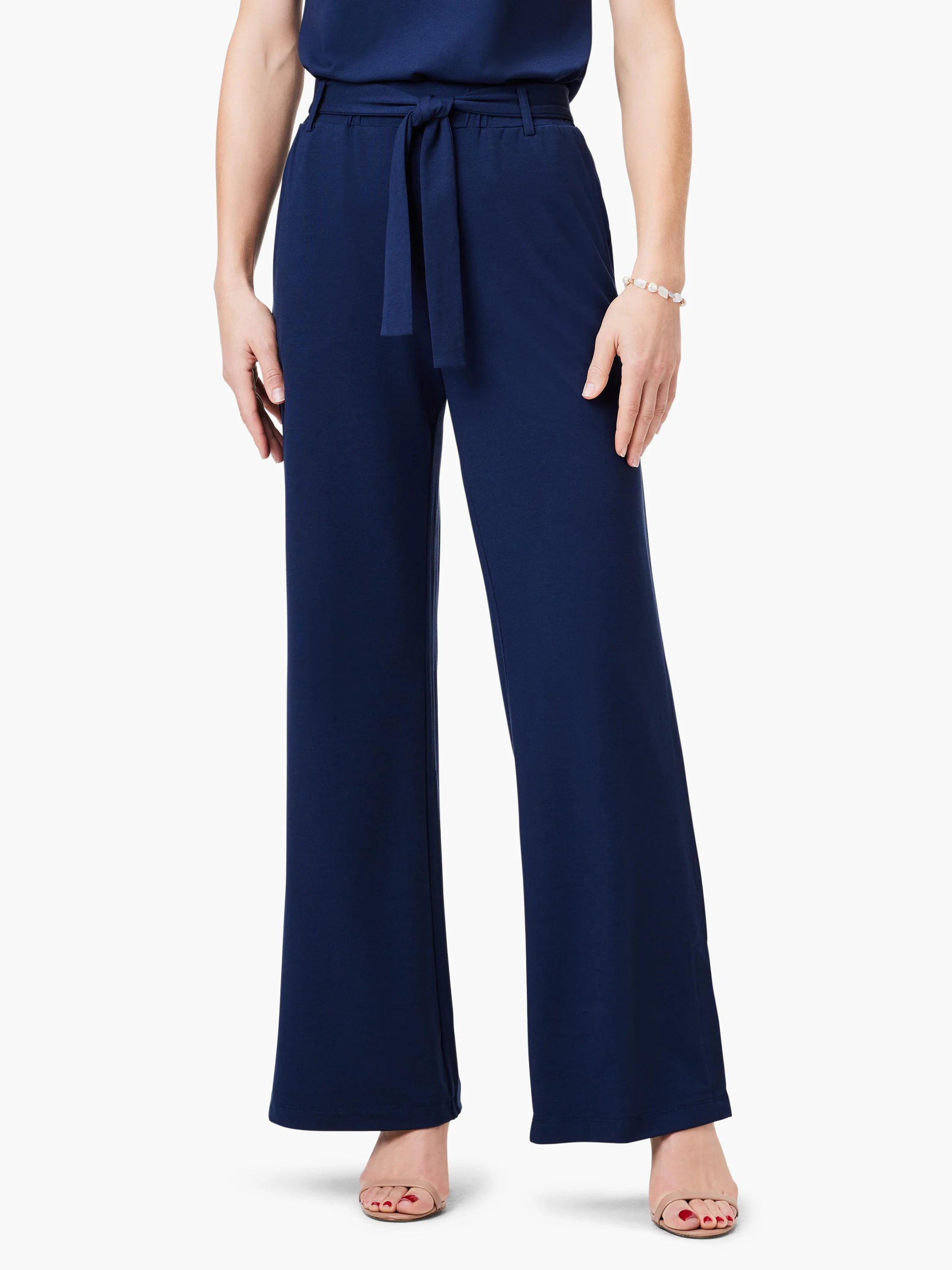 Navy blue wide-leg pants with a self-tie belt.  The pants are shown on a model.
