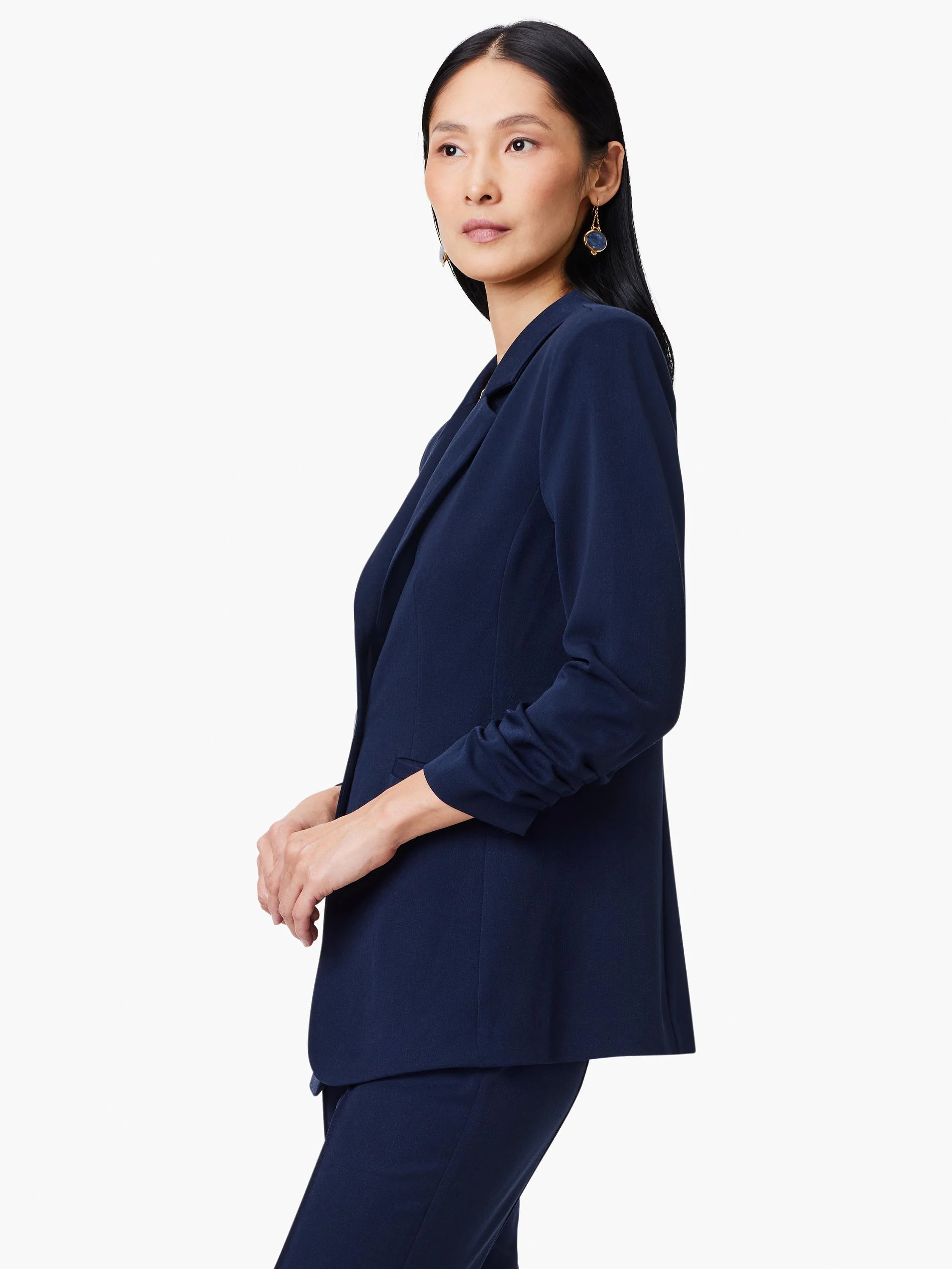Navy blue blazer, open front, three-quarter sleeves with slight scrunch at cuffs.  Shown on a model.