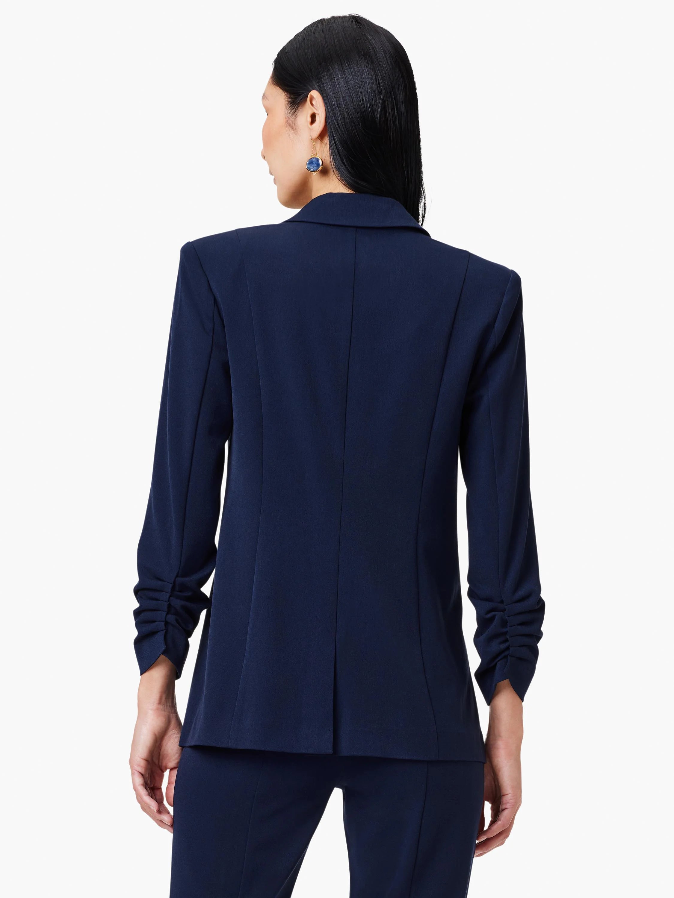Navy blue blazer, rear view.  Scrunch sleeve detail.  Padded shoulders.