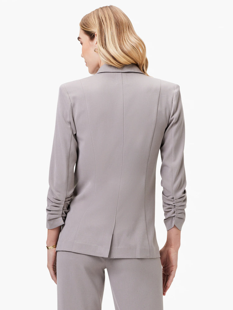 Here's alt text for the image, under 125 characters:

"Gray blazer, shown from the back.  Features scrunched sleeves and...