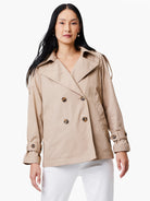 Beige double-breasted trench coat with dark buttons and belted cuffs.