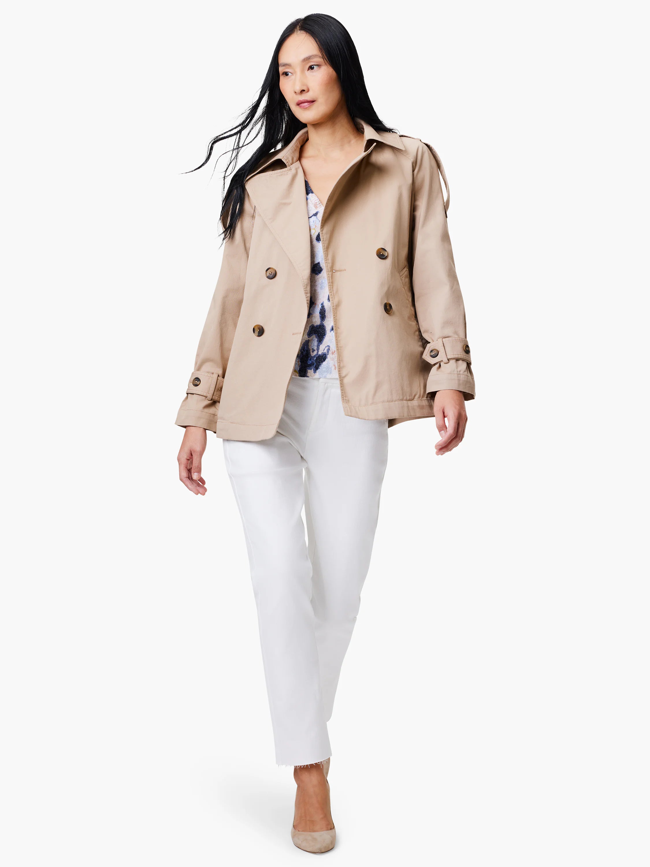 Beige double-breasted trench coat with belted cuffs.  Model shown wearing it.